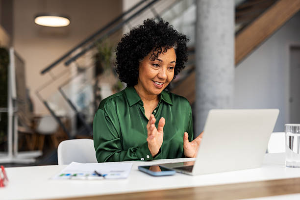 istock Professional Woman Engaged in Virtual Meeting Using a Laptop 2209334320