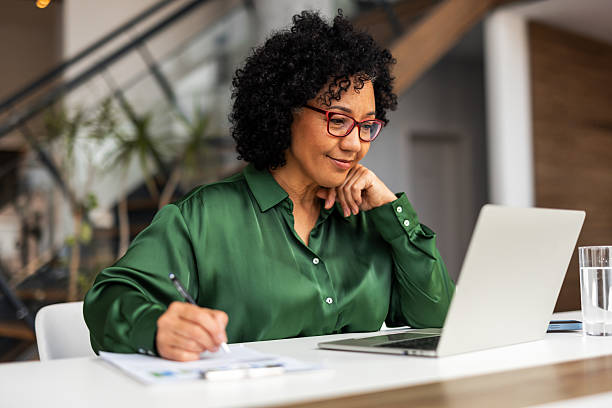 istock Professional Woman Working on Laptop in Modern Office Setting 2209334358