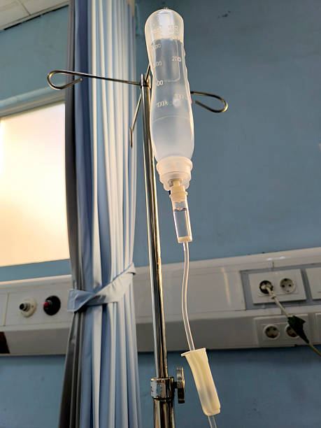 istock Close-Up View of Saline Drip Hanging on Metal Hook 2209334921