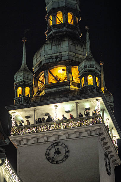 istock A beautifully illuminated historic clock tower at night, adorned with festive decorations and warm lighting. The architectural details and glowing windows create a magical and timeless atmosphere, wit 2209335386
