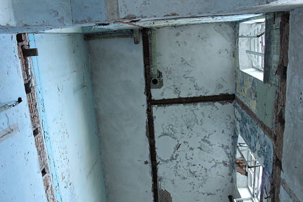 An old ruined house with collapsed stairs and floor slabs.