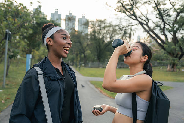istock Two Friends Drinking Whey Protein Before Their Yoga Session in the Park 2209335897