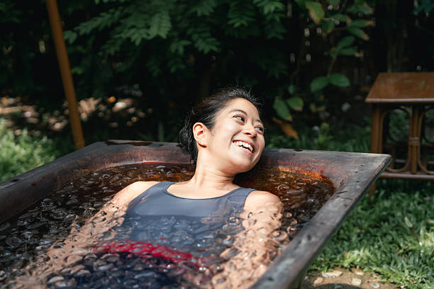 istock Women practicing necessary steps for ice bath therapy, pinching their noses with their fingers to hold their breath 2209336180