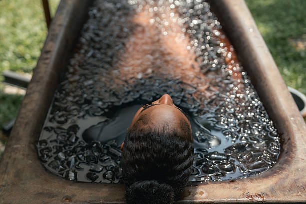 istock Women practicing necessary steps for ice bath therapy, pinching their noses with their fingers to hold their breath 2209336185