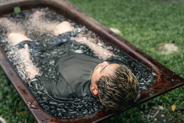 istock Men practicing necessary steps for ice bath therapy, pinching their noses with their fingers to hold their breath 2209336540