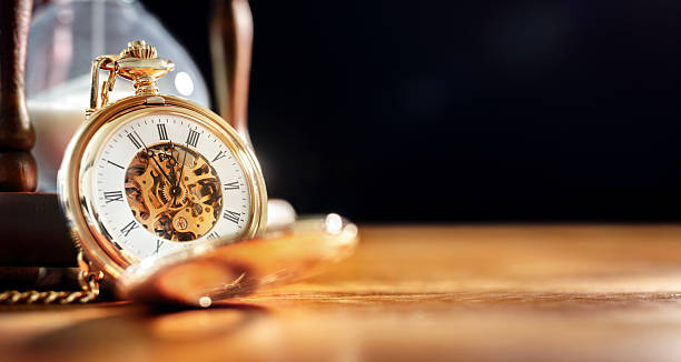 istock Gold pocket watch and hourglass background 2209336853