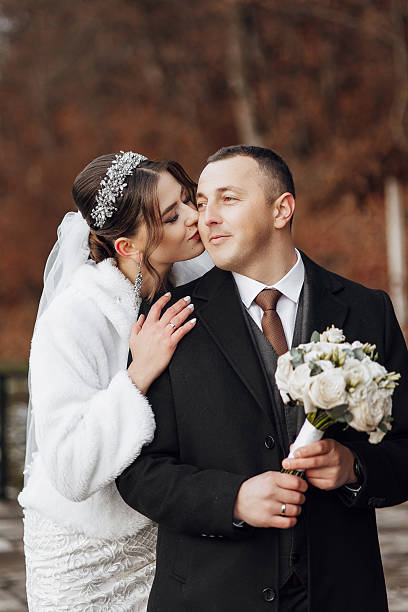 istock A bride and groom are kissing each other's cheeks 2209337258