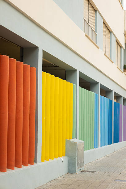 istock Vertical image of multi colored painted concrete bars on a building 2209342557