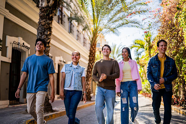 istock Young friends talking and walking on the city 2209345448