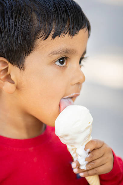 istock Close up cute little boy enjoying ice cream cones in summers. 2209346065