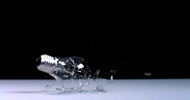 Bullet hole on glass against black background.