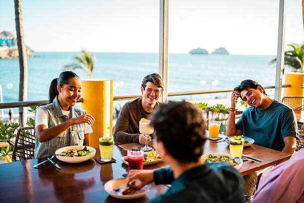 istock Young friends talking at restaurant 2209346457