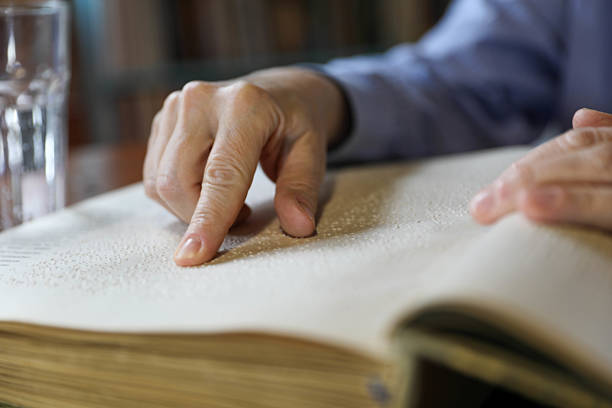 istock A Blind Man Over 50 Reading Braille Book 2209346462