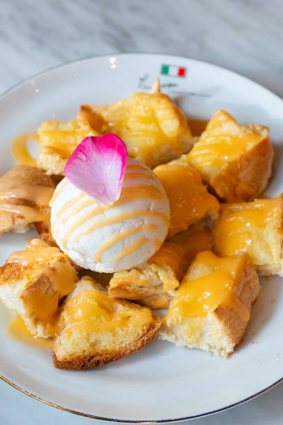 Sweet and soft toast bread coated with butter. Topped with custard and vanilla ice cream