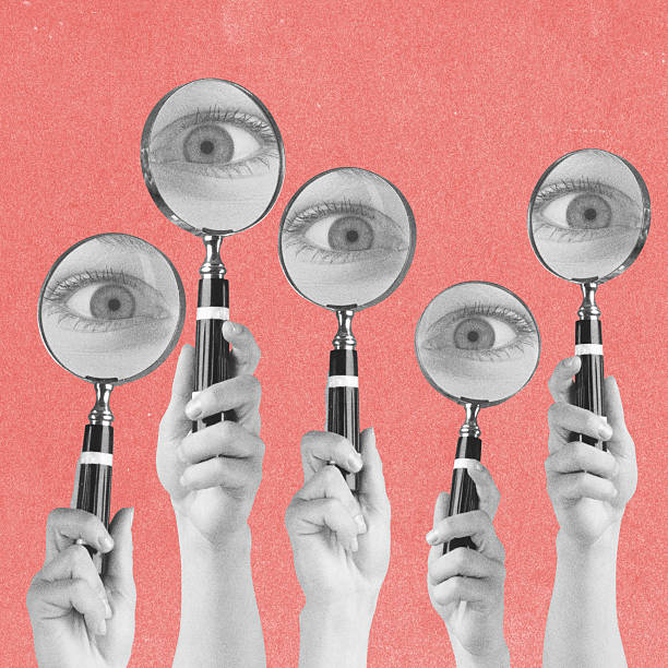istock Magnifying loop glasses and big eyes in pink background 2209350337