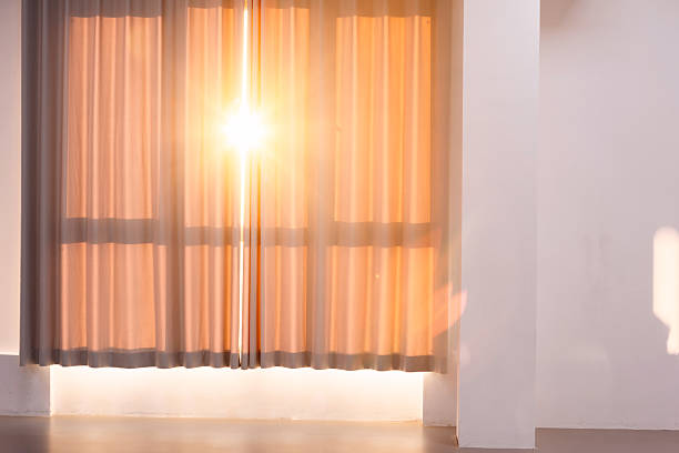 The sunset shines through the curtains in the dance classroom