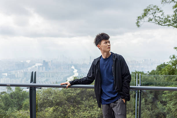 istock The young man standing on the mountaintop 2209351324