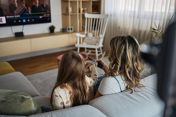 istock Mother and daughter watching TV 2209355553