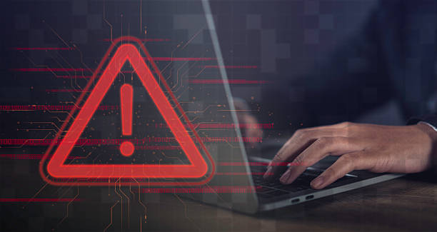 istock Cybersecurity Alert warning of Digital Risks and Information Threats caution signs on computers and laptops, highlighting the importance of secure communication and data protection. 2209356244
