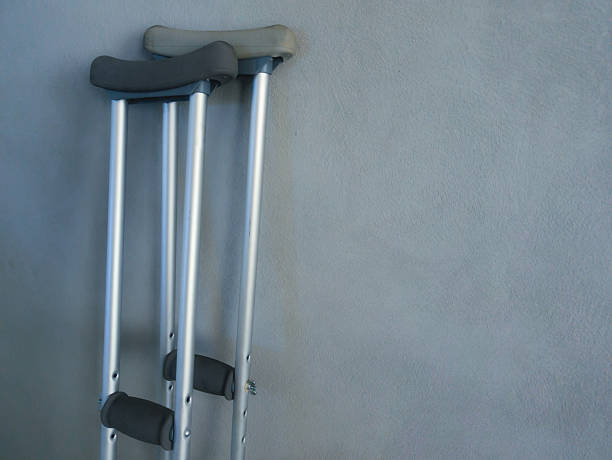 istock two crutches near the grey wall 2209356785