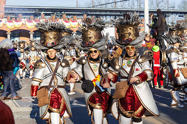 Aalst, Belgium, 3 March 2025: Brightly dressed female Carnival dancers participating in Aalst Mardi Gras celebrations. The annual Carnival parade attracts 100 000 spectators each year. Copy space.