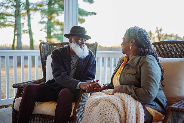 istock Senior couple relaxing on patio at sunset 2209364635
