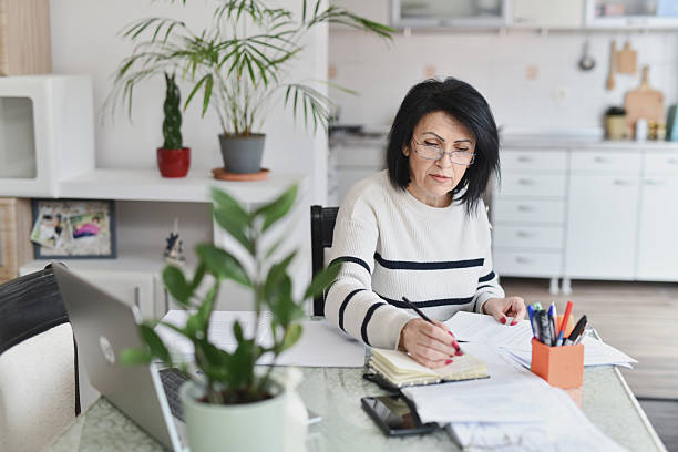 istock Beautiful Woman Deep in Thought While Reviewing Important Documents at Home 2209366513