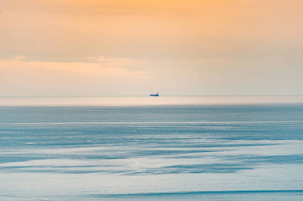 White sailing boat on  sea water, blue sky. Asturias, Spain. Image suitable for background purposes.