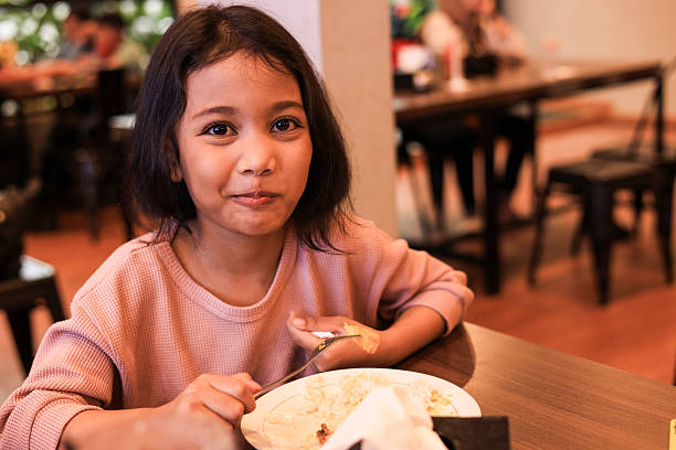 A Girl Eating Meals on Restaurant