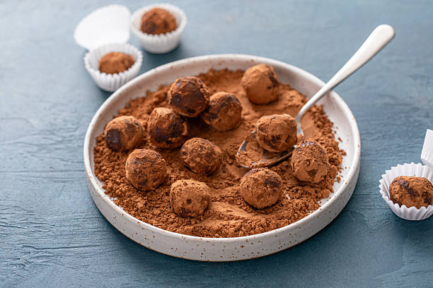 istock Dark chocolate ganache truffles tossed with cocoa 2209371299