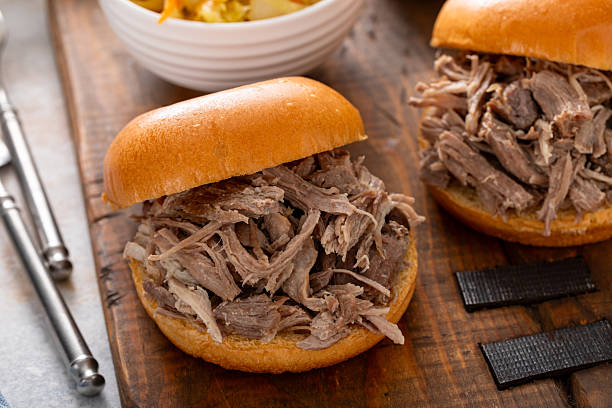 istock Pulled pork sandwiches on brioche buns with BBQ sauce and cabbage 2209371358