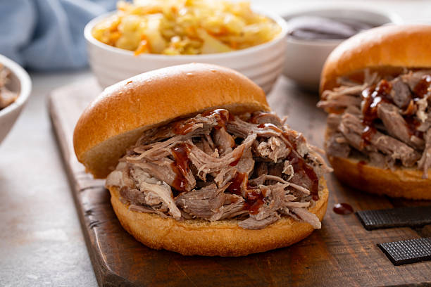 istock Pulled pork sandwiches on brioche buns with BBQ sauce and cabbage 2209371359