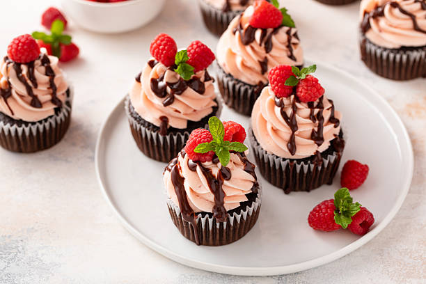 istock Raspberry chocolate cupcakes with raspberry buttercream frosting a drizzle of chocolate glaze 2209371426