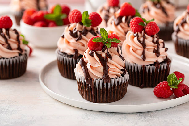 istock Raspberry chocolate cupcakes with raspberry buttercream frosting a drizzle of chocolate glaze 2209371444