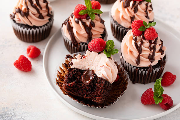istock Raspberry chocolate cupcakes with raspberry buttercream frosting and chocolate filling 2209371451