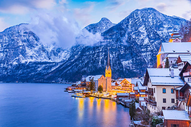 istock Hallstatt, Austria. Serene Alpine village with snow-covered rooftops on tranquil lake, breathtaking mountain backdrop winter twilight 2209372226