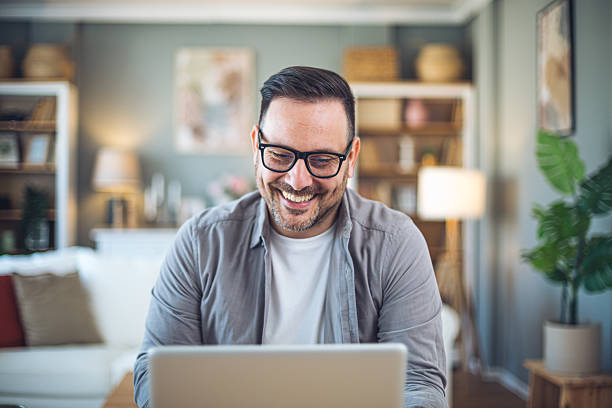 istock Smiling freelancer working from home on laptop 2209372609