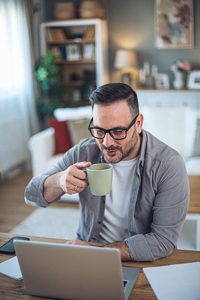 istock Happy freelancer enjoying a cup of coffee while working from home 2209372664