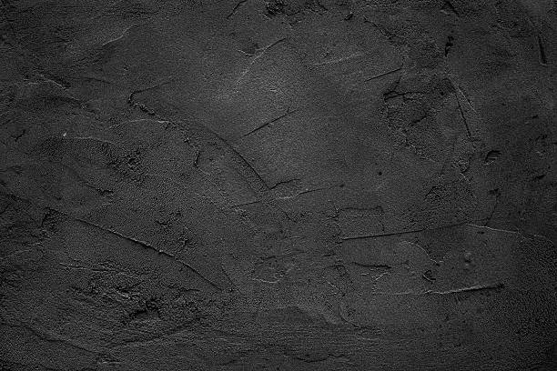 istock Rough black plastered stone wall texture showcasing natural imperfections and depth in minimalist setting 2209374289