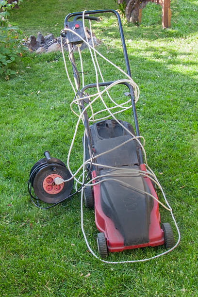 istock red electric lawn mower on green under cut lawn, 2209377209