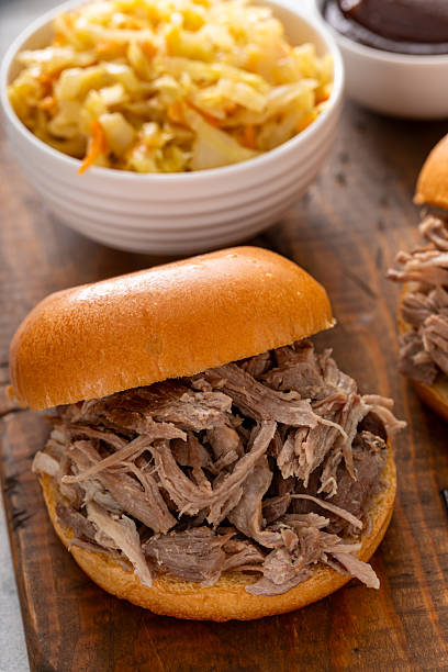 istock Pulled pork sandwiches on brioche buns with BBQ sauce and cabbage 2209378097