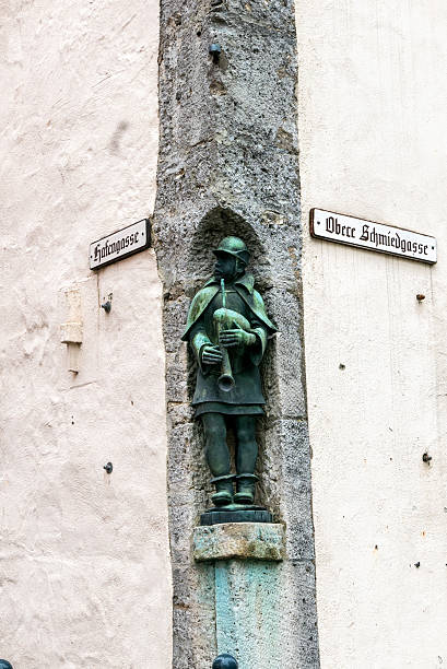 ROTHENBURG OB DER TAUBER, GERMANY - JUNE 12 , 2019: sculpture of a piper in a corner of the city