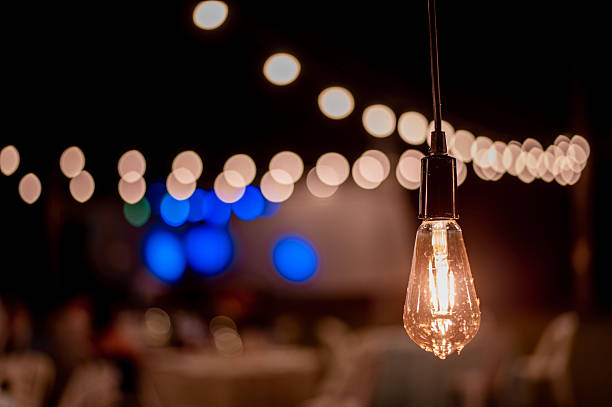 istock Close up of yellow light bulbs on a clothesline 2209378950