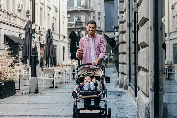istock Father Strolling with Baby in Urban Setting 2209382750