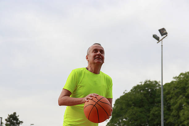 istock Mature man playing basketball 2209384144