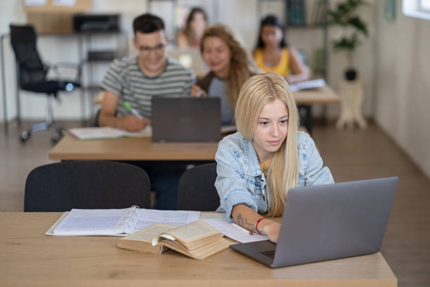 istock Portrait of a beautiful university student sitting in a library while doing her researches 2209392157