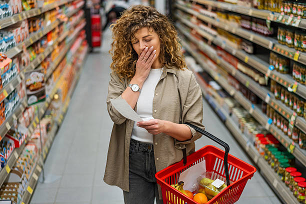 istock Woman examining her grocery bill with concern 2209394434