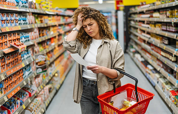 istock Concerned woman checking high prices on her grocery bill 2209394499