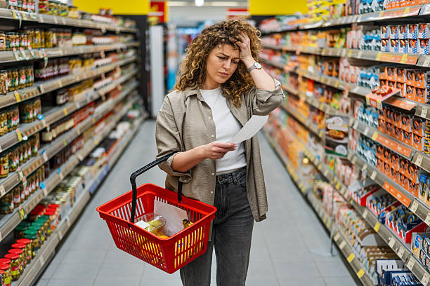 istock Concerned woman checking high prices on her grocery bill 2209394836