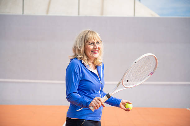 istock Senior woman playing tennis 2209395389